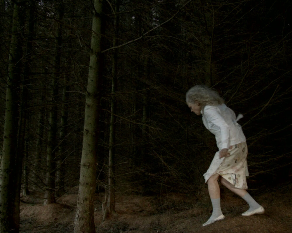 Original video art, figure walking in woods